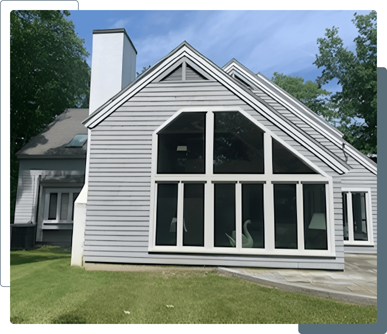 Modern house with large windows and lawn.
