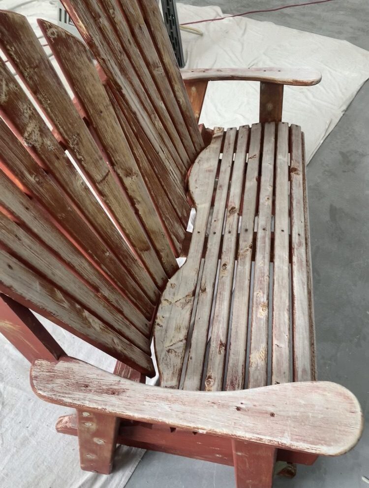 Weathered wooden bench on concrete floor.