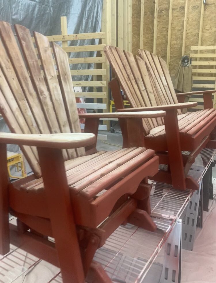 Wooden Adirondack chairs in a workshop.