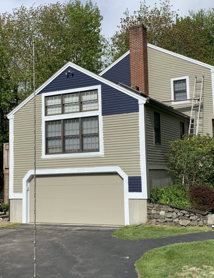 House with garage and ladder outside.